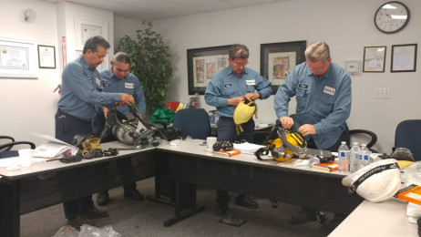 Workers putting on safety equipment